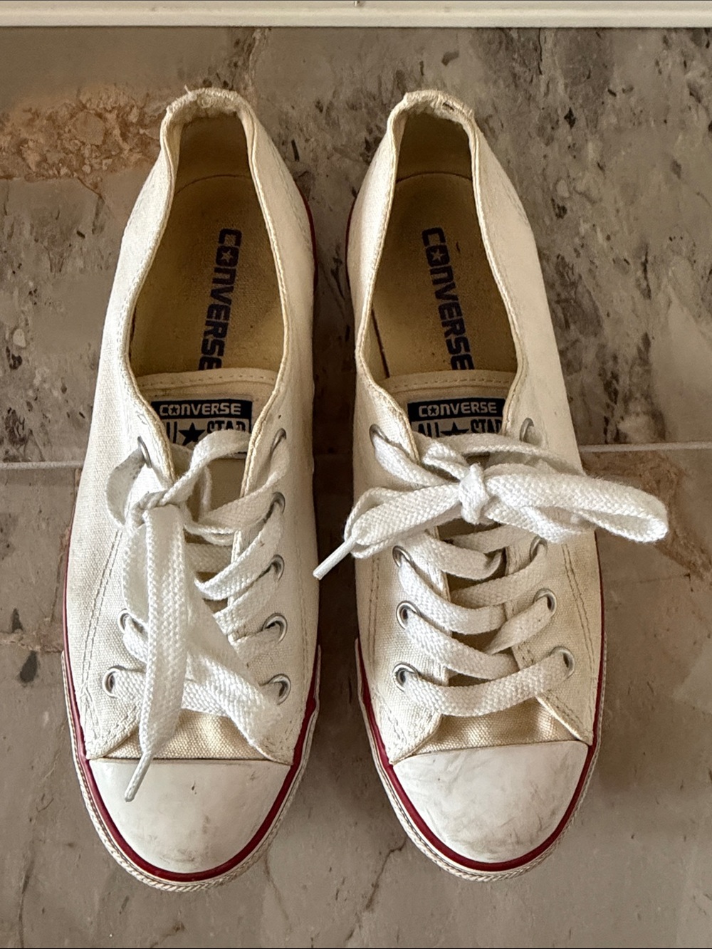 Converse white low-top sneakers with red trim